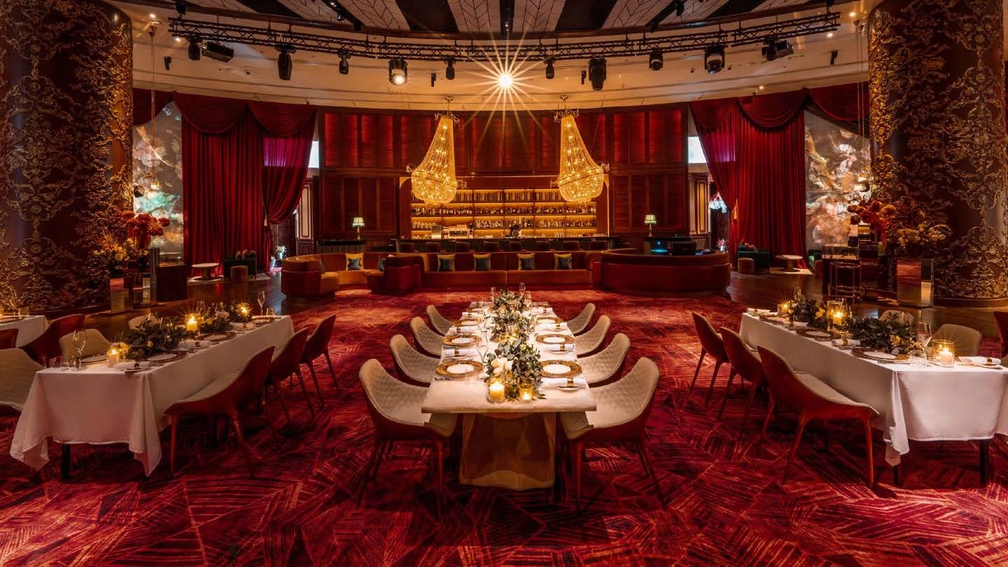 The Belcanto dining room at Dubai Opera, set for a banquet beneath two crystal chandeliers